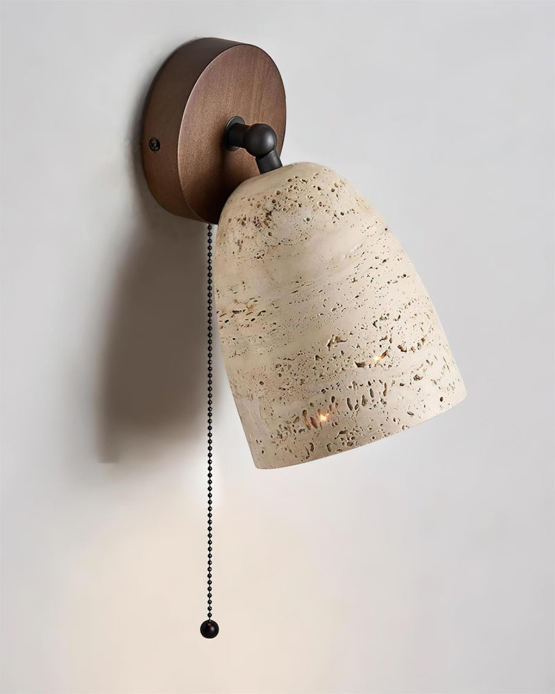 Travertine wall sconce PERA No.01 with the dome tilted sideways as a reading light, walnut plate, lit