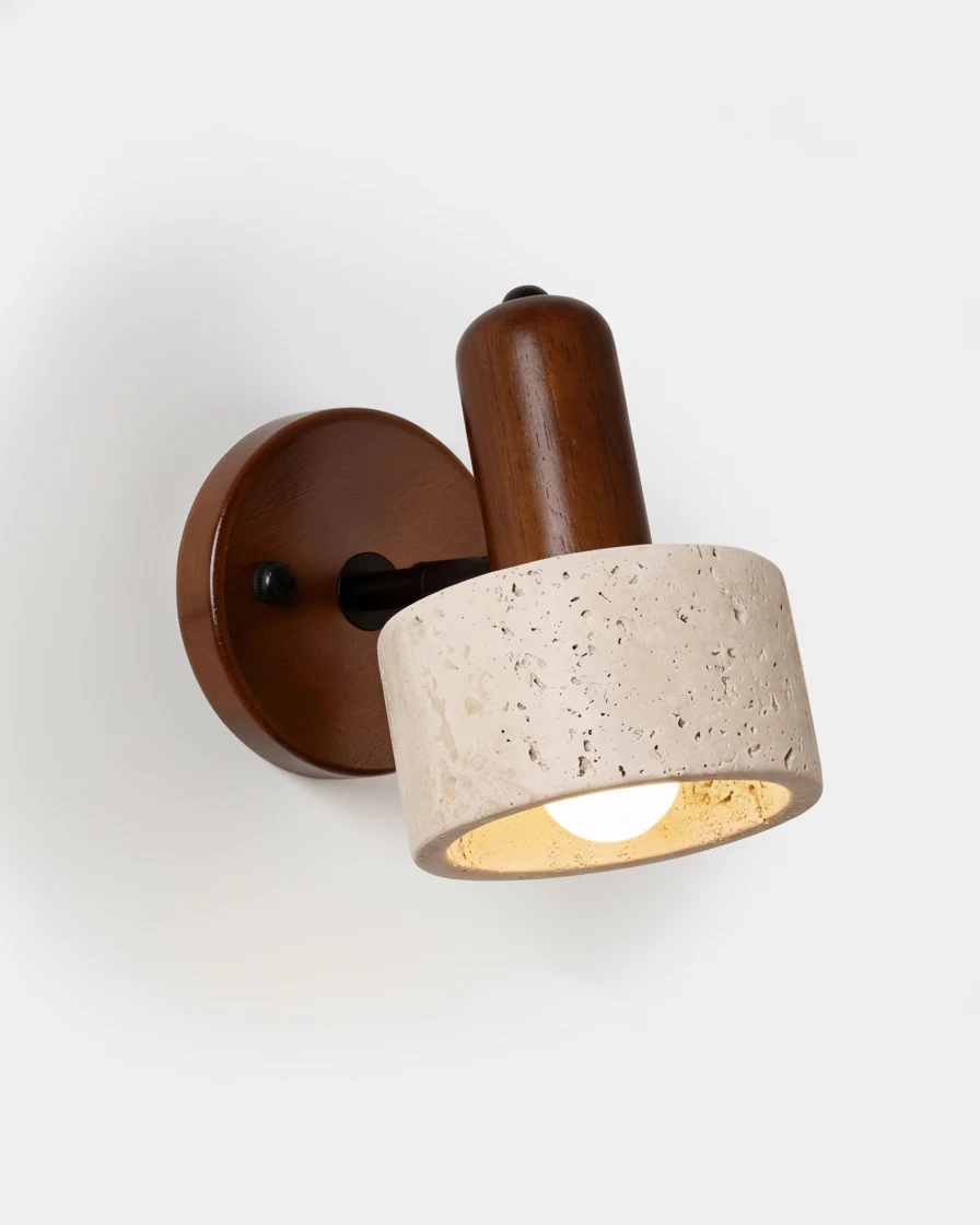 Travertine wall sconce CONA No.01, cylinder stone head on a dark walnut backplate, switched on