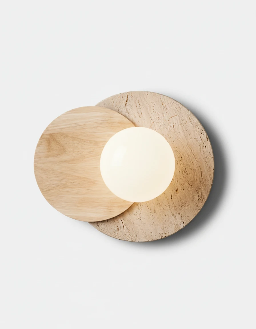Travertine wall sconce AVORIO No.02 with light oak disc overlapping yellow travertine, globe switched on