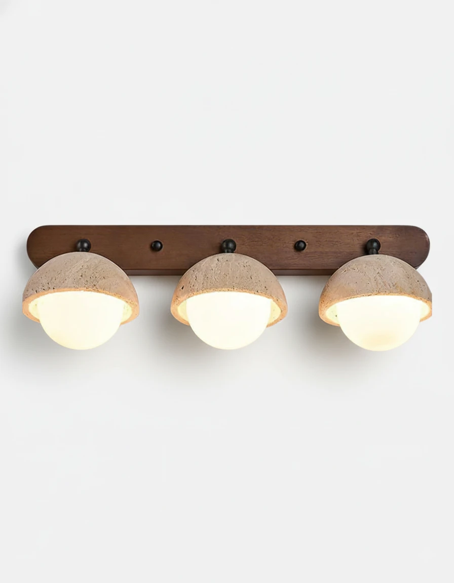 Travertine wall sconce AURA No.02 Triple Globe, three beige stone half-domes with lit opal globes on a walnut bar