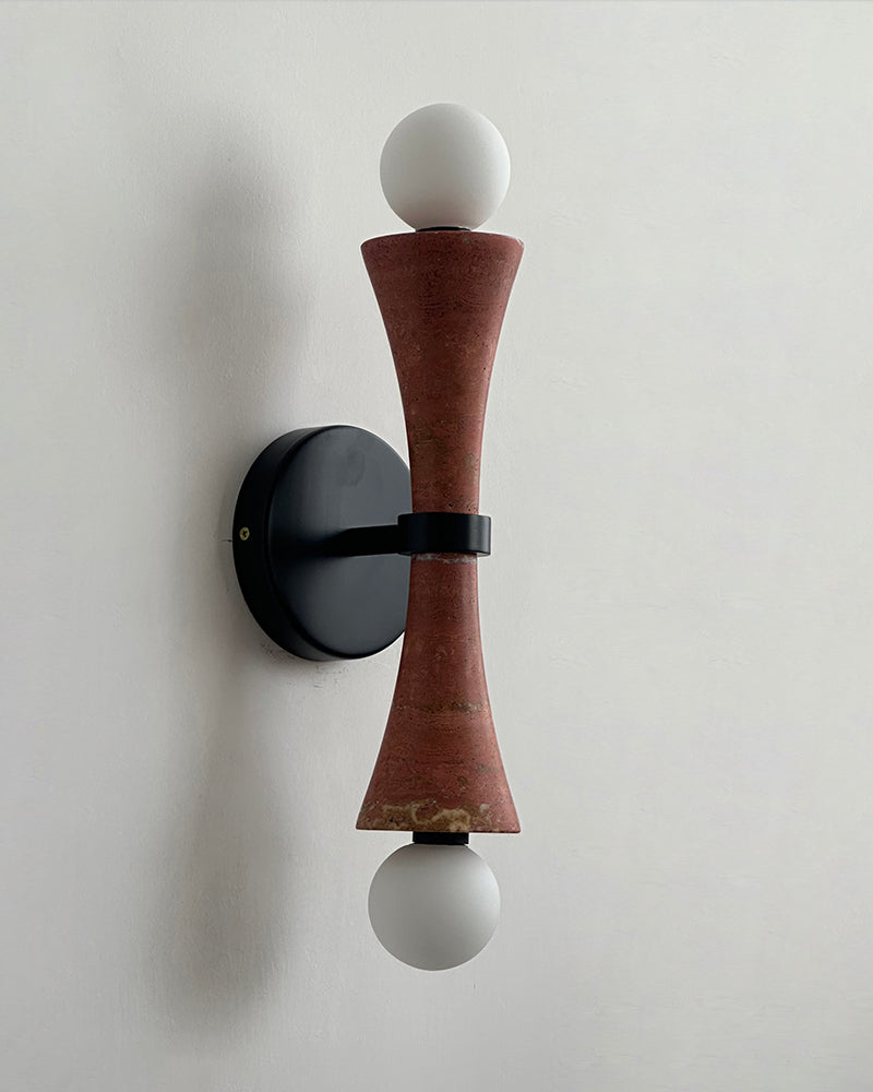 Travertine wall sconce VETTA No.01 in red travertine, rust-toned hourglass with opal globes on a black backplate