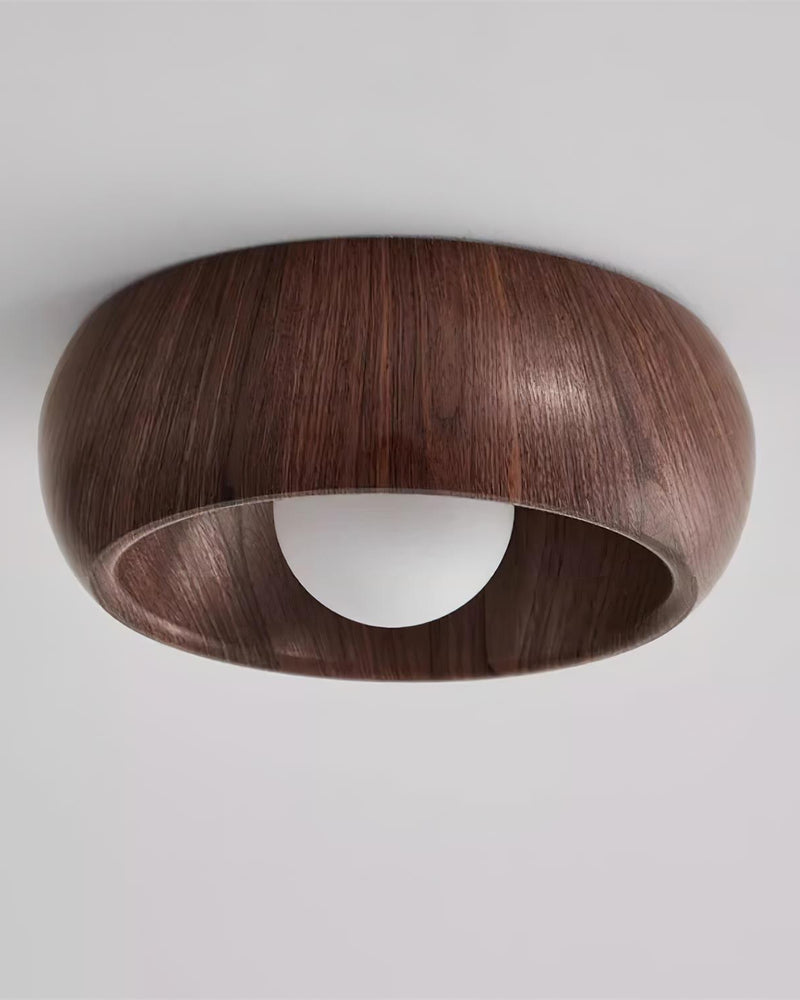 Wood flush mount ceiling light OMBRA No.01, dark walnut dome with the opal bulb unlit, angled view on a plain background