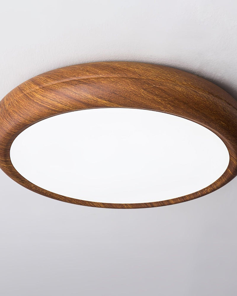 Wood flush mount ceiling light COMO No.01, rounded wood drum with a cool white lit panel, close packshot