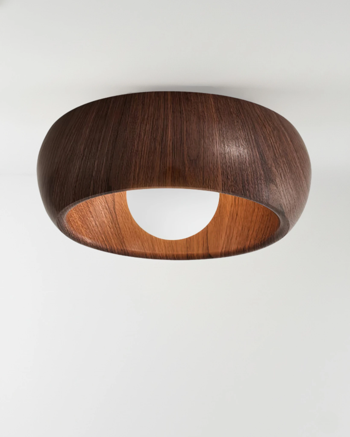 Wood flush mount ceiling light OMBRA No.01 in Dark Walnut, rounded wood dome with the opal bulb switched on