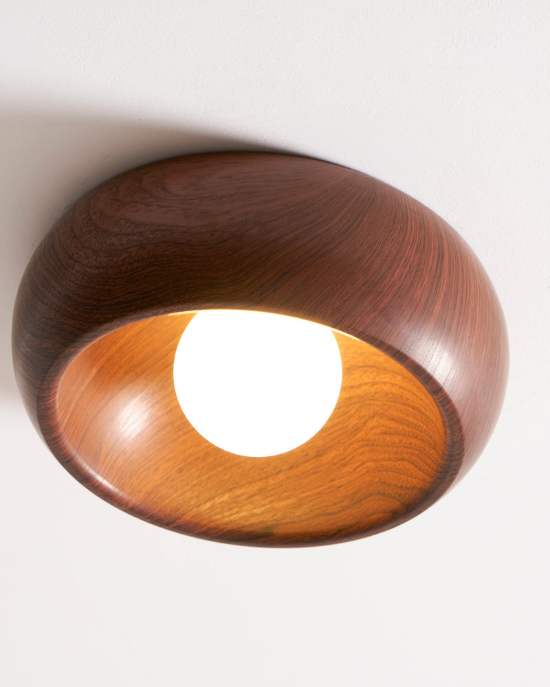 Wood flush mount ceiling light OMBRA No.01, dark walnut dome seen from below with the opal bulb switched on
