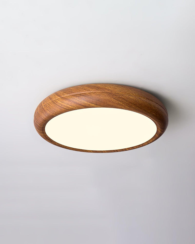 Wood flush mount ceiling light COMO No.01 in Natural Grain, 12 in drum glowing warm white on a plain ceiling