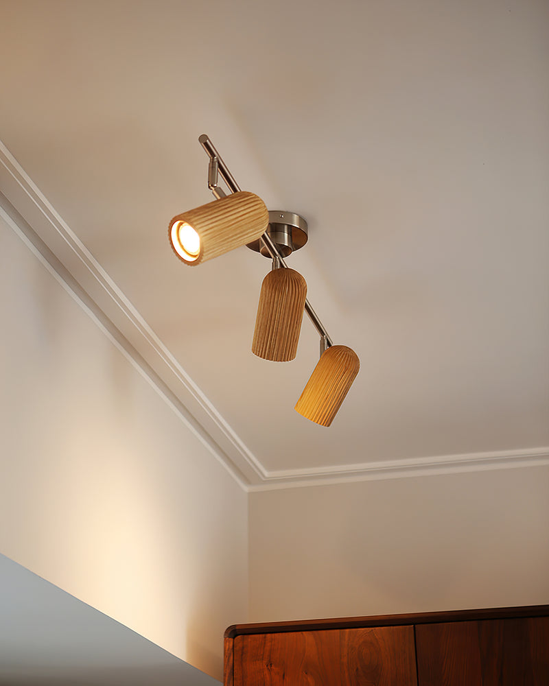 Wood flush mount ceiling light RIGA No.06 with three spots glowing on a ceiling with crown molding