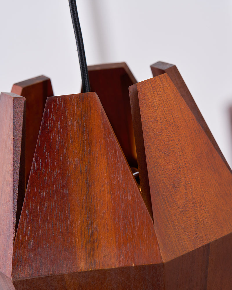 Close-up of the angled walnut fins and grain of the ORBIT No.01 wood pendant light near the cord entry