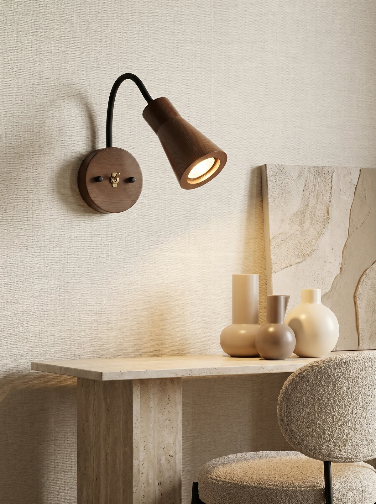 Wood wall sconce RIGA No.07 in dark walnut lit above a travertine console with ceramic vases and a boucle chair