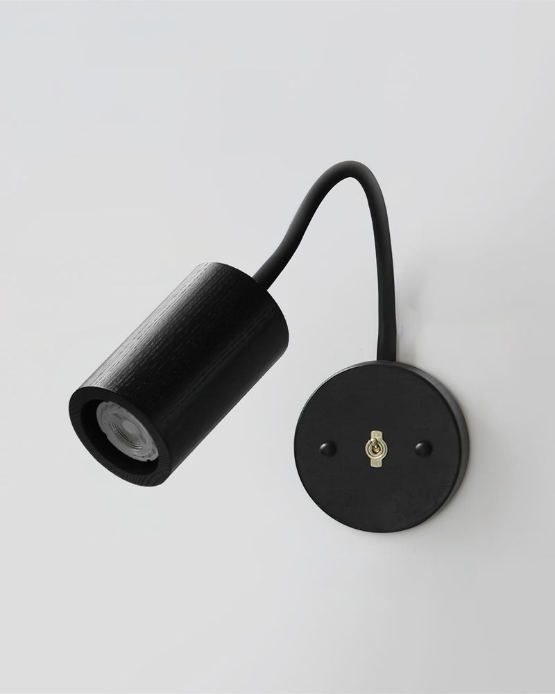 Wood wall sconce RIGA No.07 in blackened oak with a cylinder head, black flexible arm and matching backplate