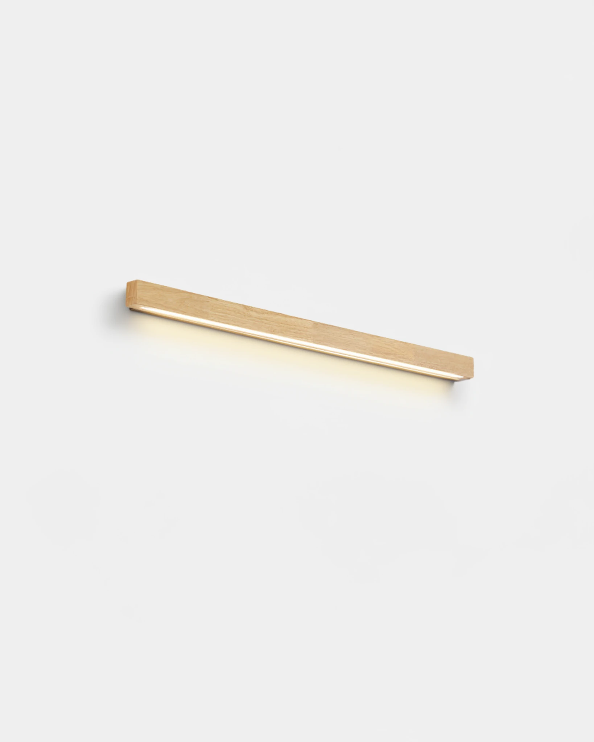 Wood wall sconce PIANO No.01 in light walnut, 60 cm bar with a down-only LED lit on a white wall