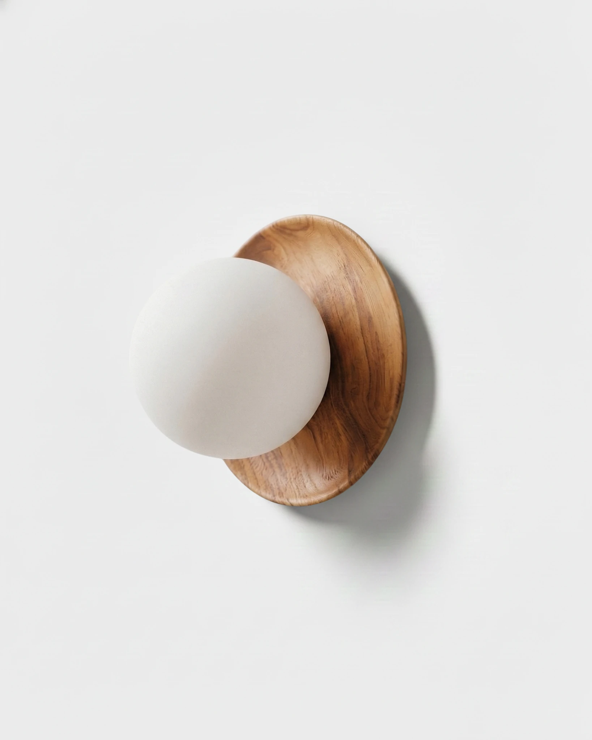 Wood wall sconce MURA No.02 in natural ash, white opal globe on a pale wood halo, white background