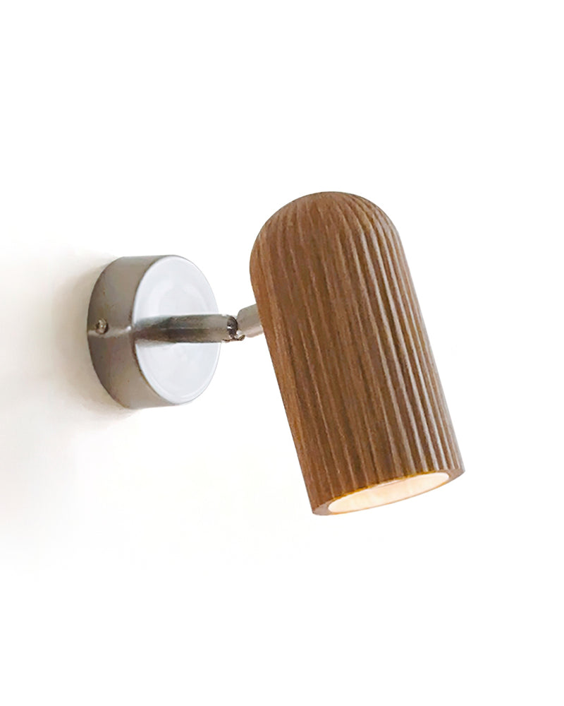 Wood wall sconce NOTA No.01 in natural ash with nickel, fluted ash head tilted on a round nickel bracket